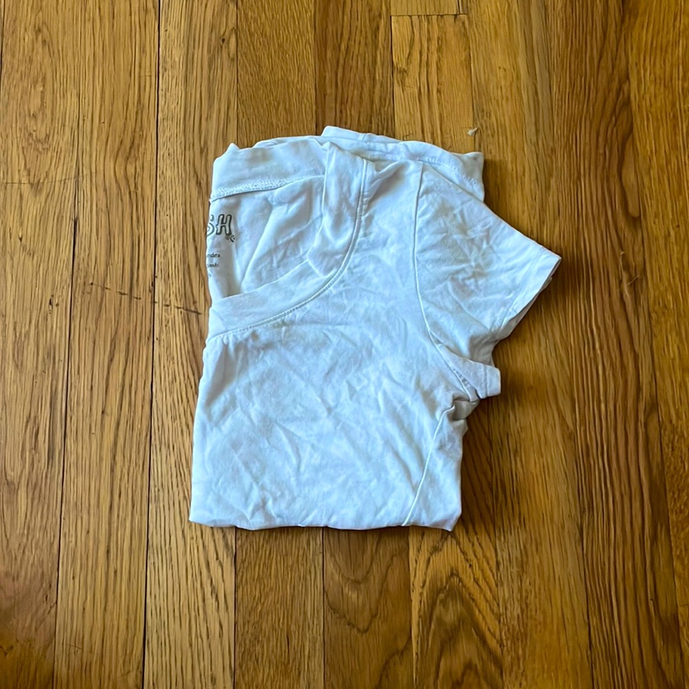To small. Very cute white V line shirt! Never worn.